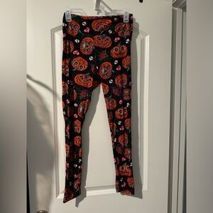 Pumpkin Leggings
Size medium 
Orange black and pink